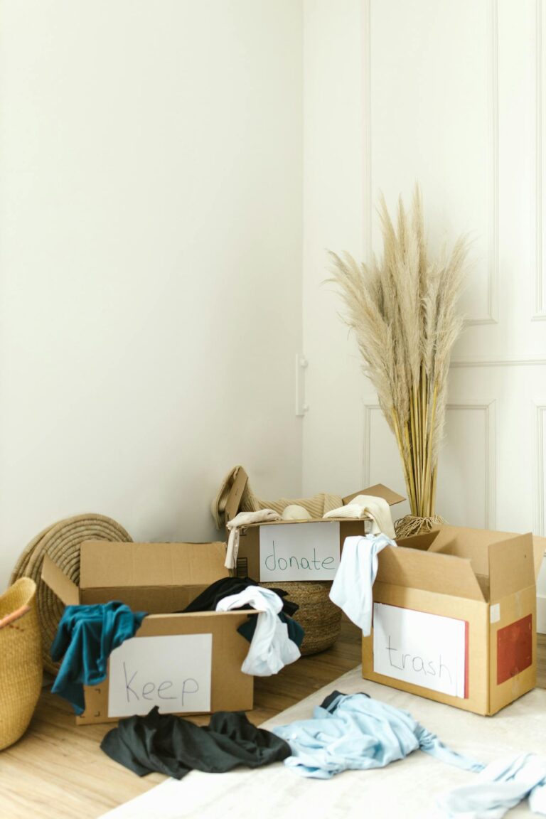 Boxes labeled keep, donate, and trash for efficient home decluttering and organization.